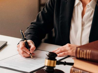 lawyer-signing-documents-with-gavel-books(1)